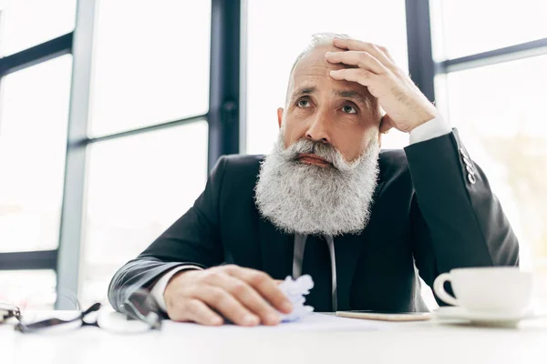 Thoughtful businessman at workplace — Stock Photo, Image