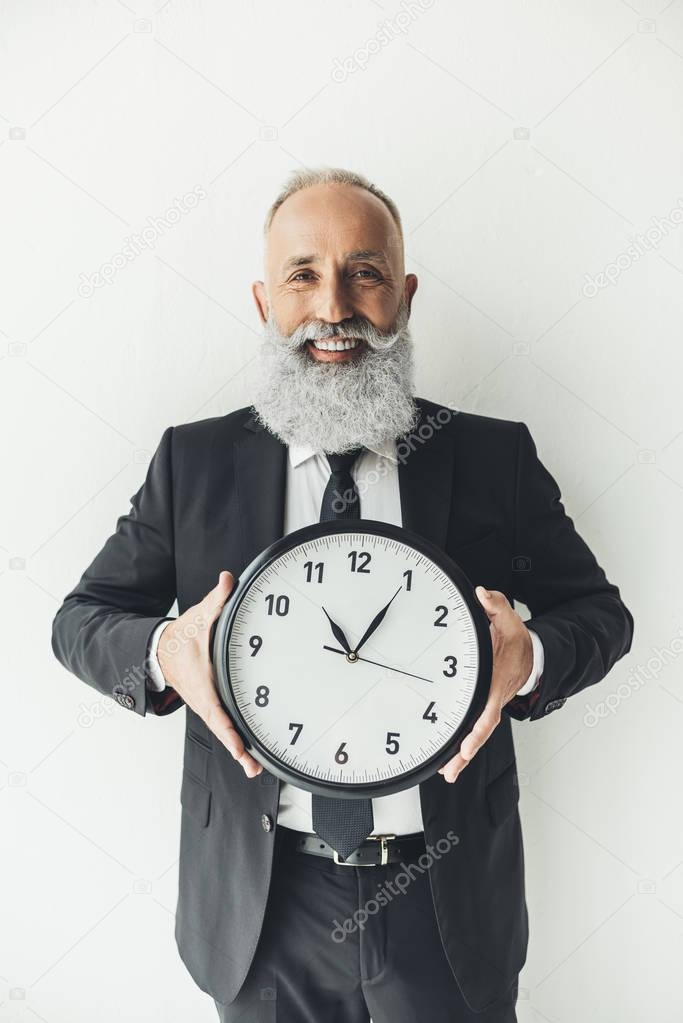 mature businessman with clock