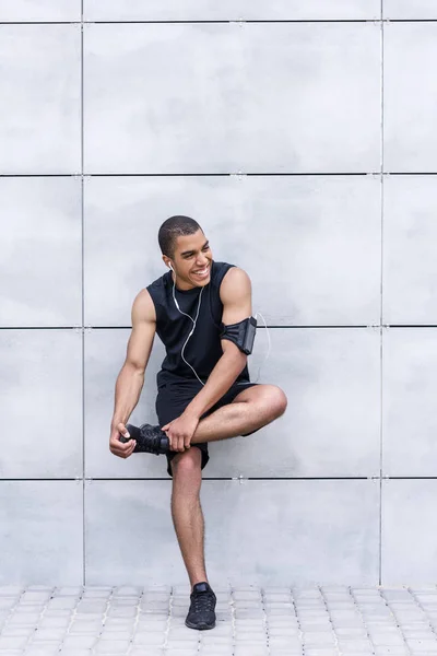 African american runner stretching on street — Stock Photo, Image