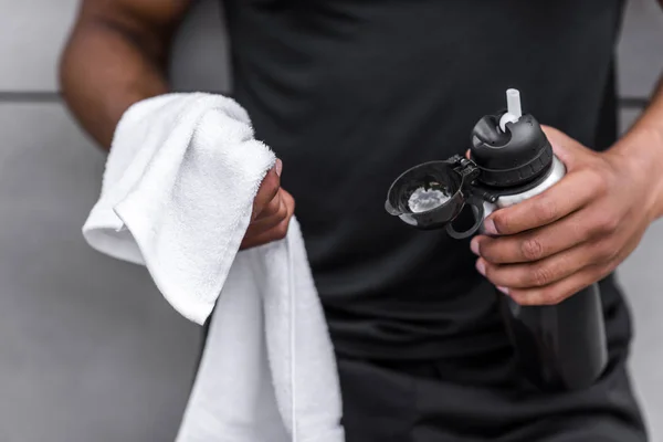 Sportsman with sports bottle and towel — Stock Photo, Image