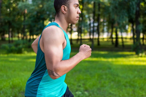 Deportista afroamericano corriendo en parque — Foto de Stock