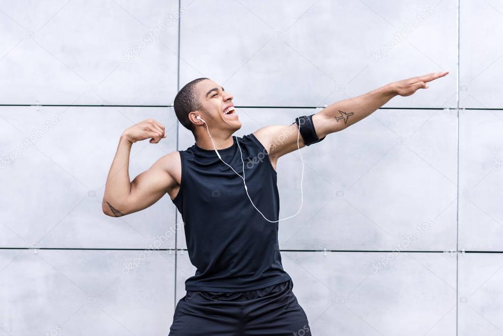 african american runner stretching on street