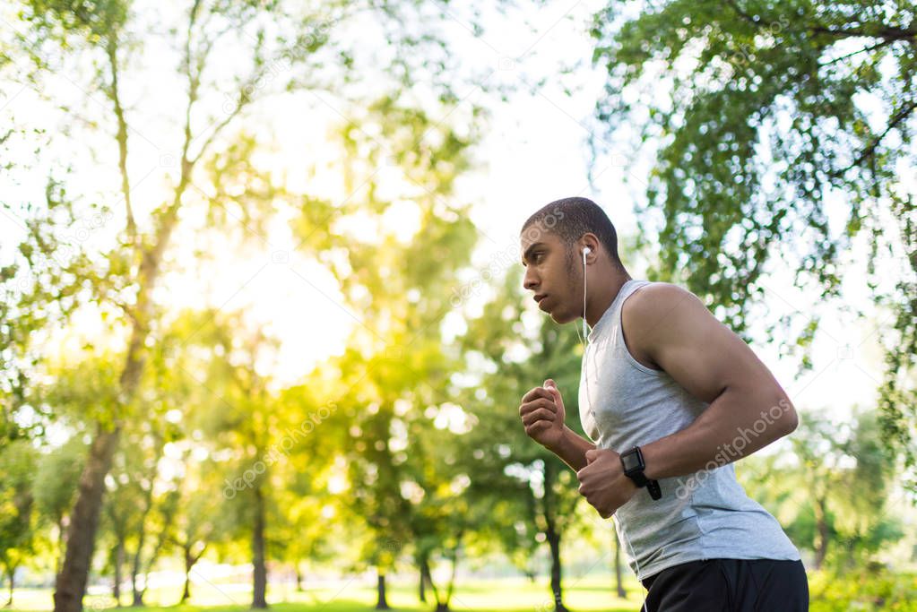 african american sportsman running in park