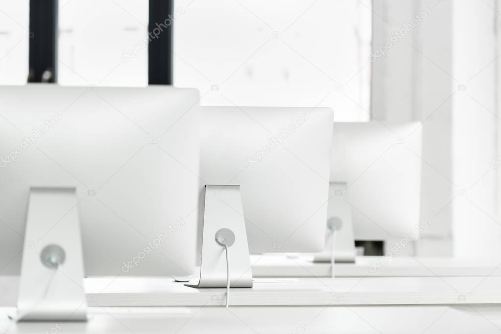 computer monitors on tables in class