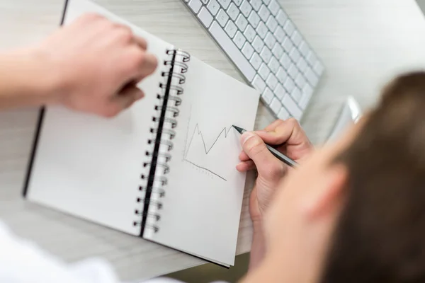 Student drawing graphic in notebook — Stock Photo, Image