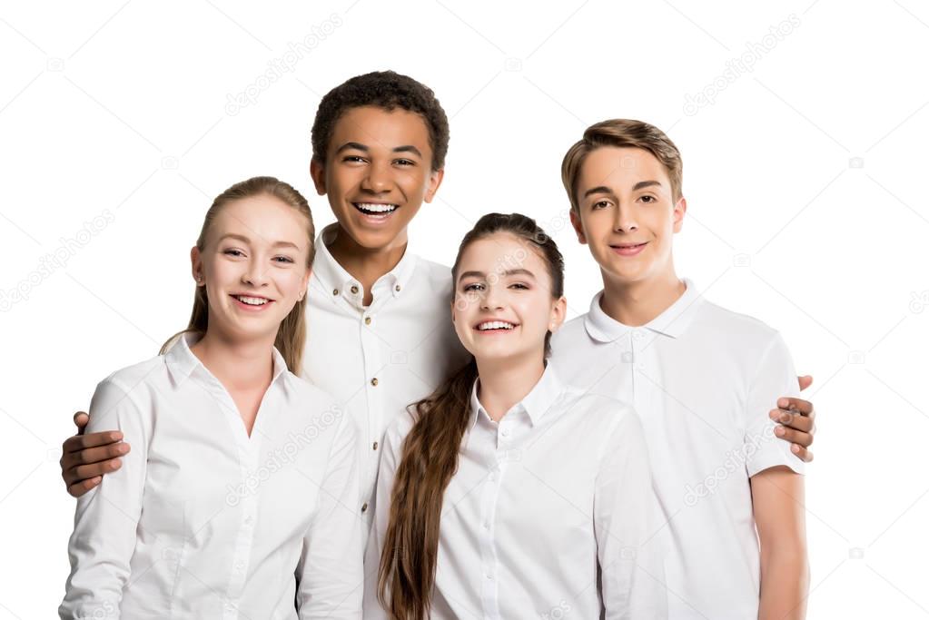 cheerful multiethnic teenagers in white shirts