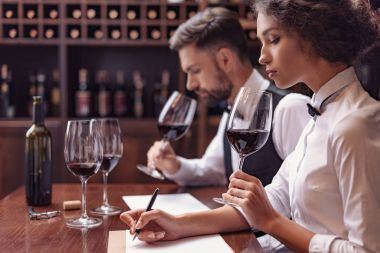 Sommeliers tasting wine in cellar clipart