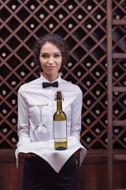 sommelier with wine in cellar clipart