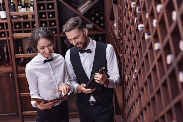 sommeliers choosing wine in cellar