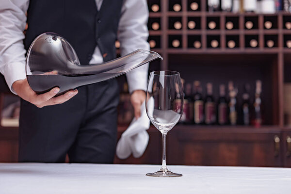 sommelier pouring red wine