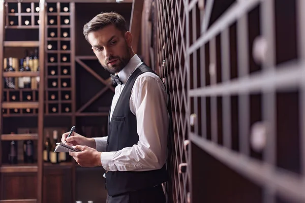 Sommelier in wine cellar — Stock Photo, Image