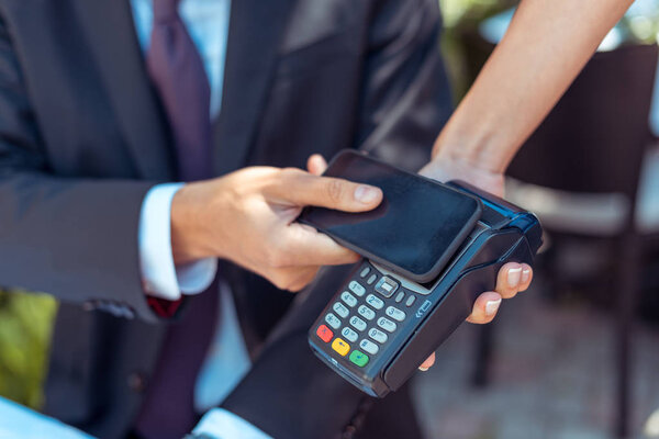 man paying with NFC technology