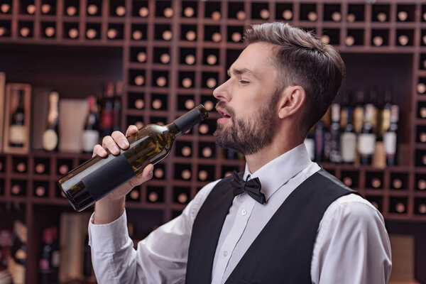Waiter drinking wine 