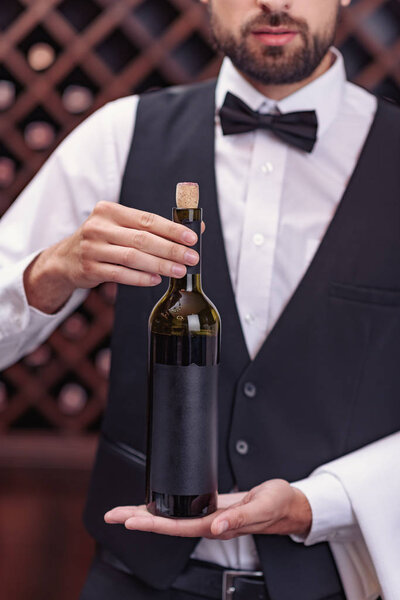 sommelier with bottle of wine