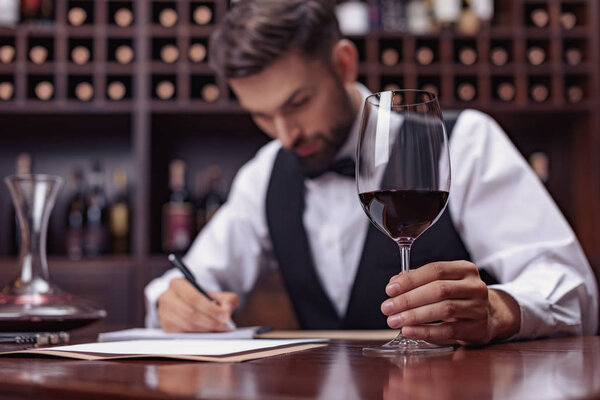 sommelier tasting wine