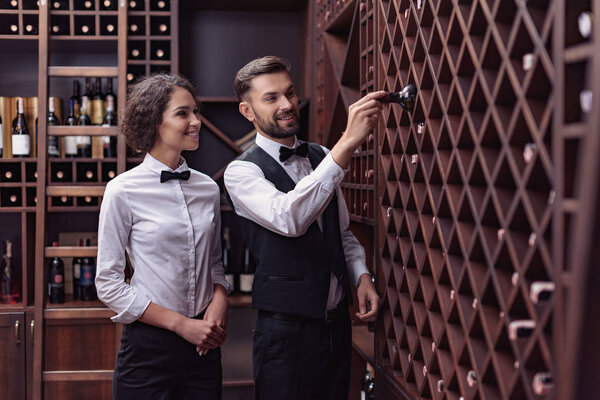 sommeliers choosing wine in cellar