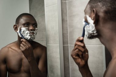 thoughtful african-american man shaving clipart