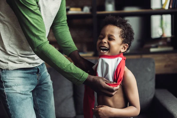 Padre vistiendo a su hijo — Foto de Stock