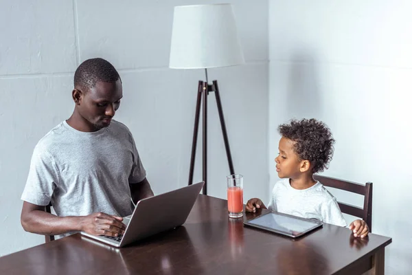 Vader en zoon met laptop en tablet — Gratis stockfoto