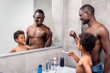 father and son brushing teeth clipart