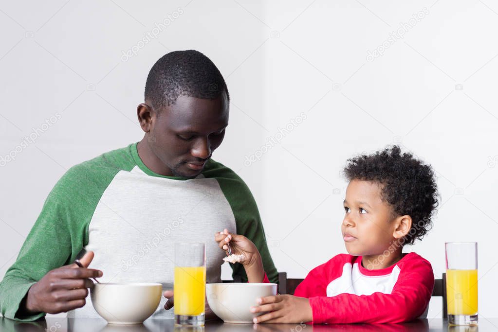 father and son eating breakfast