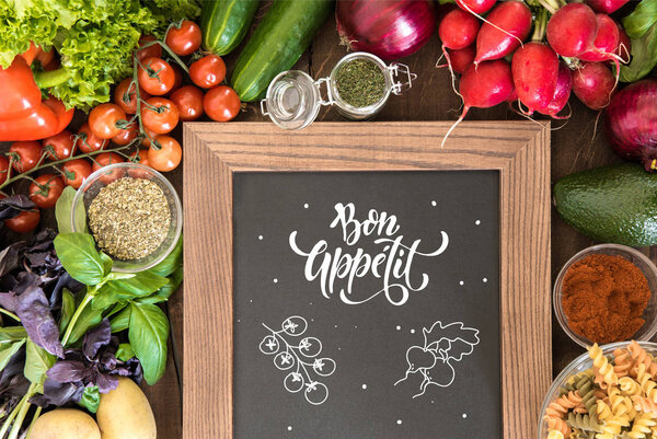 chalkboard with group of fresh vegetables 