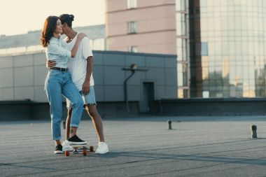 couple embracing on rooftop clipart