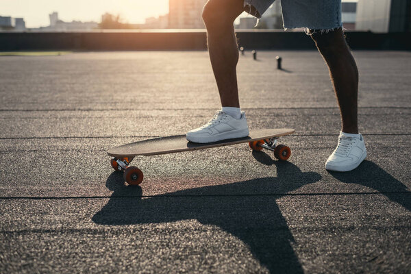 man riding on skateboard on rooftop