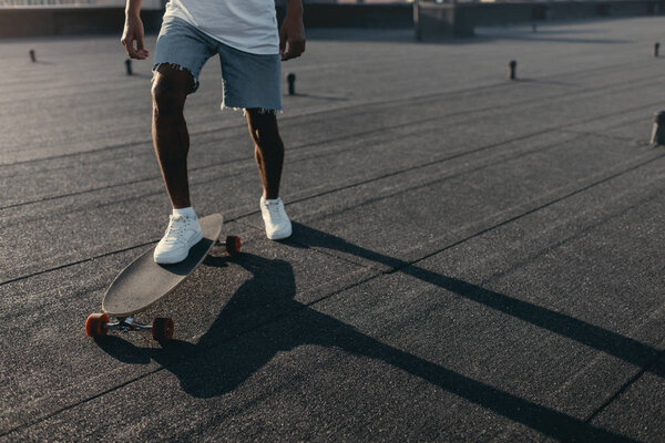 man riding on skateboard on rooftop