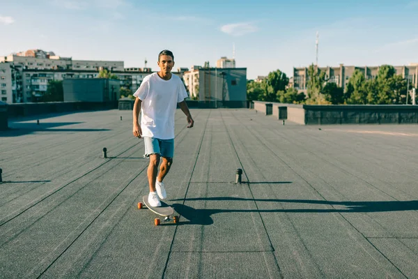 Man riding skateboard on rooftop — Stock Photo, Image