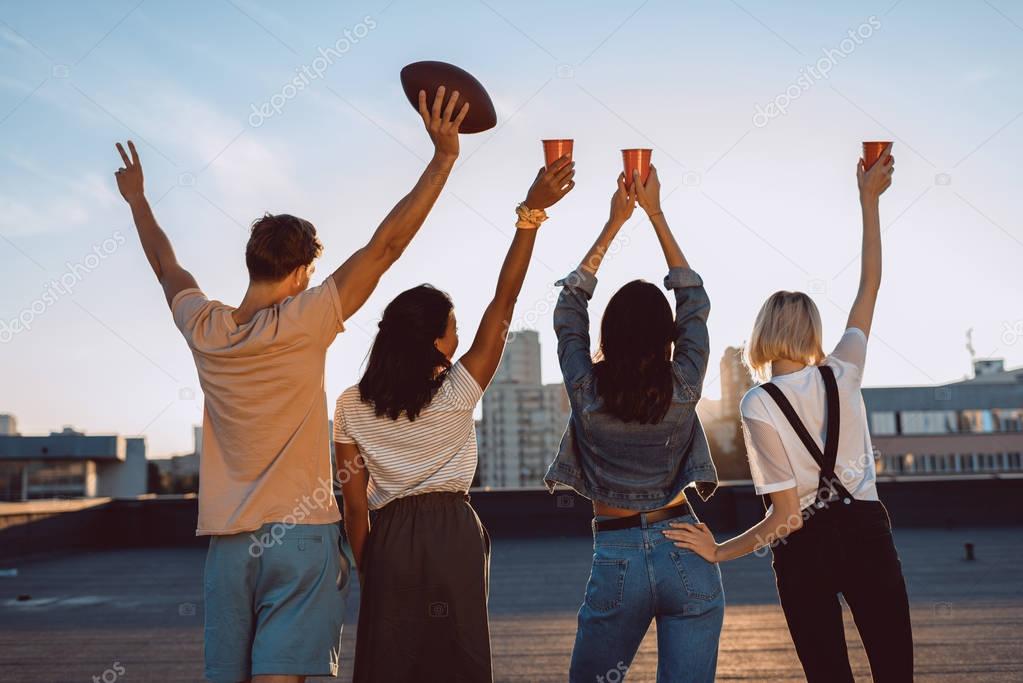 group of happy friends on roof