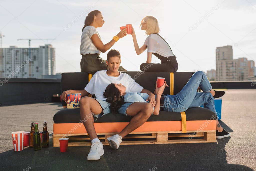friends relaxing on roof