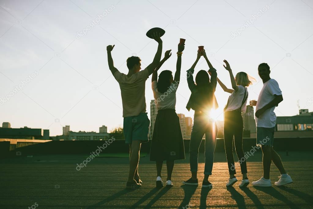 friends on roof at sunset