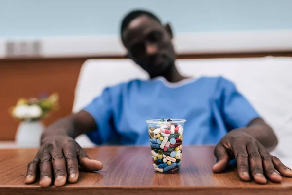 Pills in plastic glass — Stock Photo, Image