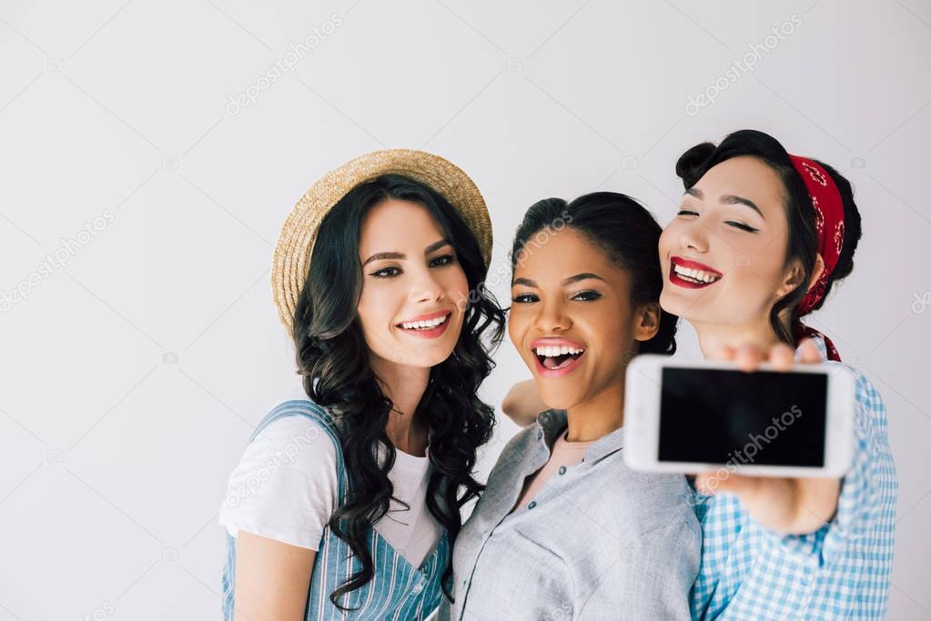 multicultural women taking selfie