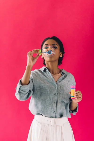 African american woman blowing soap bubbles — Free Stock Photo