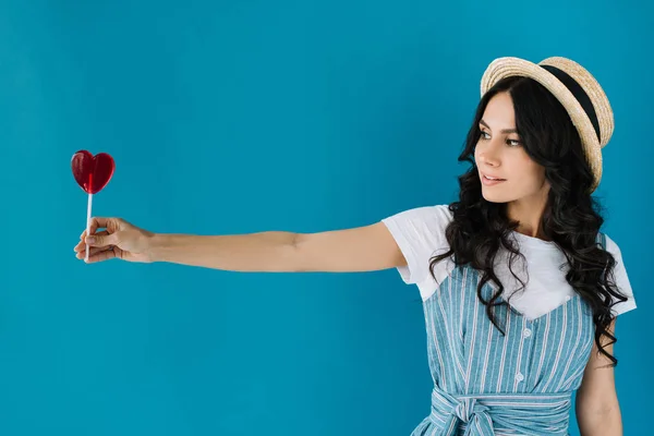 Woman holding lollipop in hand — Stock Photo, Image