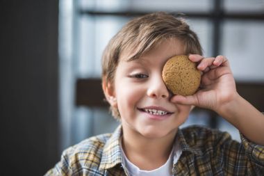 smiling little boy with cookie clipart