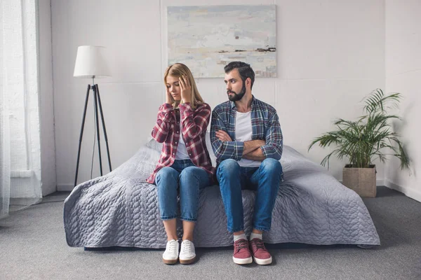 Onderbouwd paar zittend op bed — Stockfoto