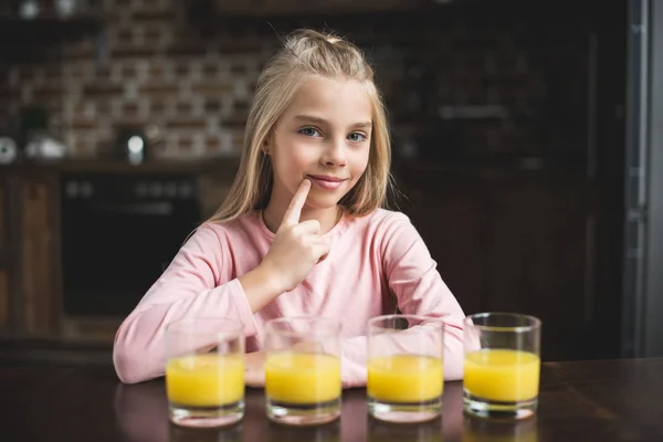 Child with glasses of juice — Free Stock Photo