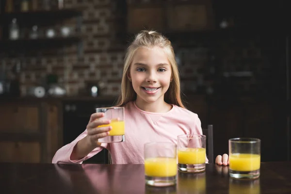 Child with glasses of juice — Free Stock Photo