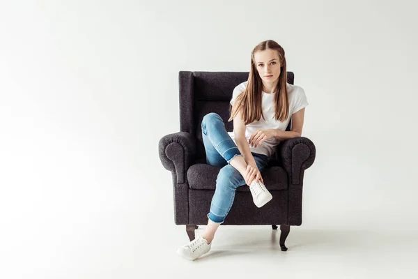 Girl sitting on armchair — Stock Photo, Image