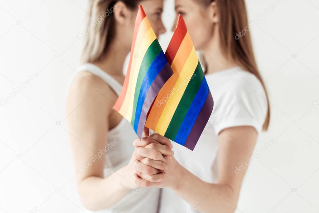 Lesbian couple with small rainbow flags