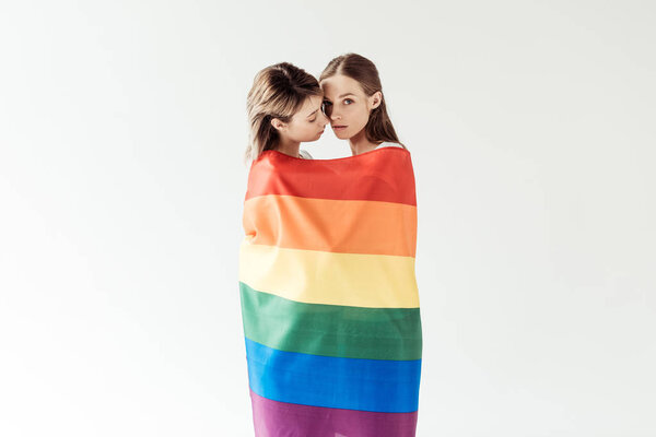 Lesbian couple wrapped in rainbow flag 