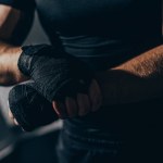 Boxer wrapping hands with bandages