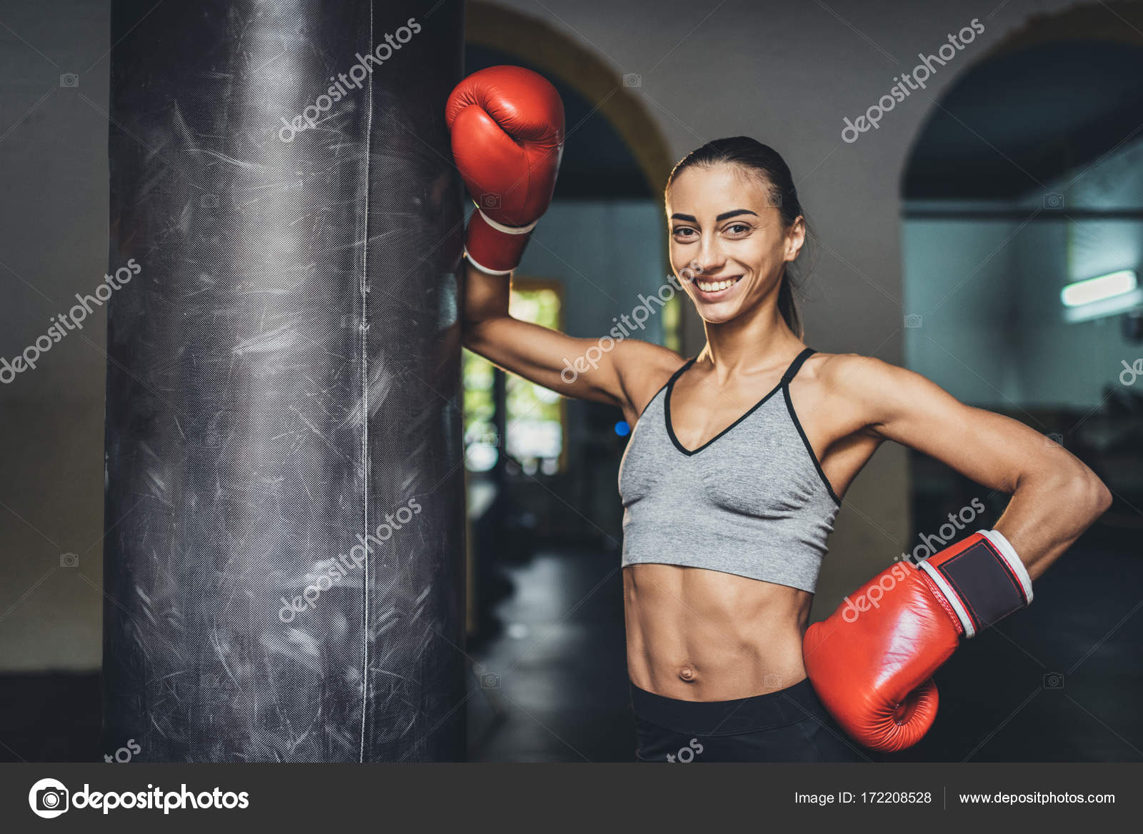 Female boxer with punching bag — Stock Photo © IgorTishenko 172208528