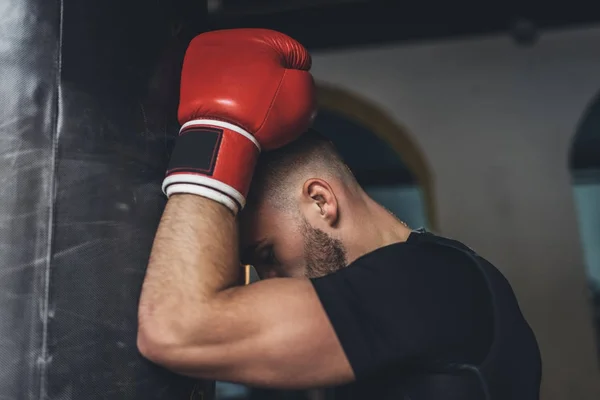 Young boxer with punching bag — Free Stock Photo