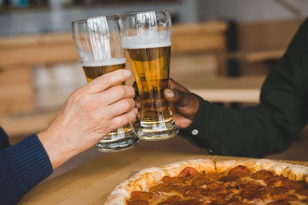 Vrienden rammelende glazen bier — Stockfoto