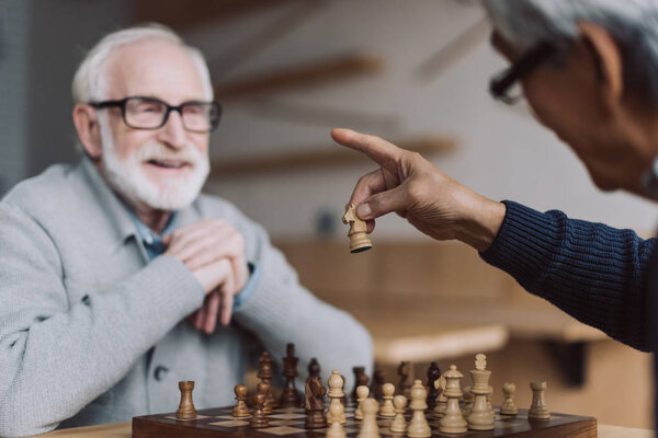 senior men playing chess