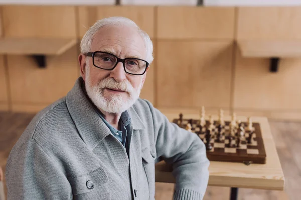 Äldre man med schackbräde — Stockfoto